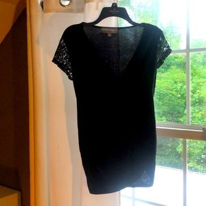 Large, Black, t-shirt with black lace sleeves.